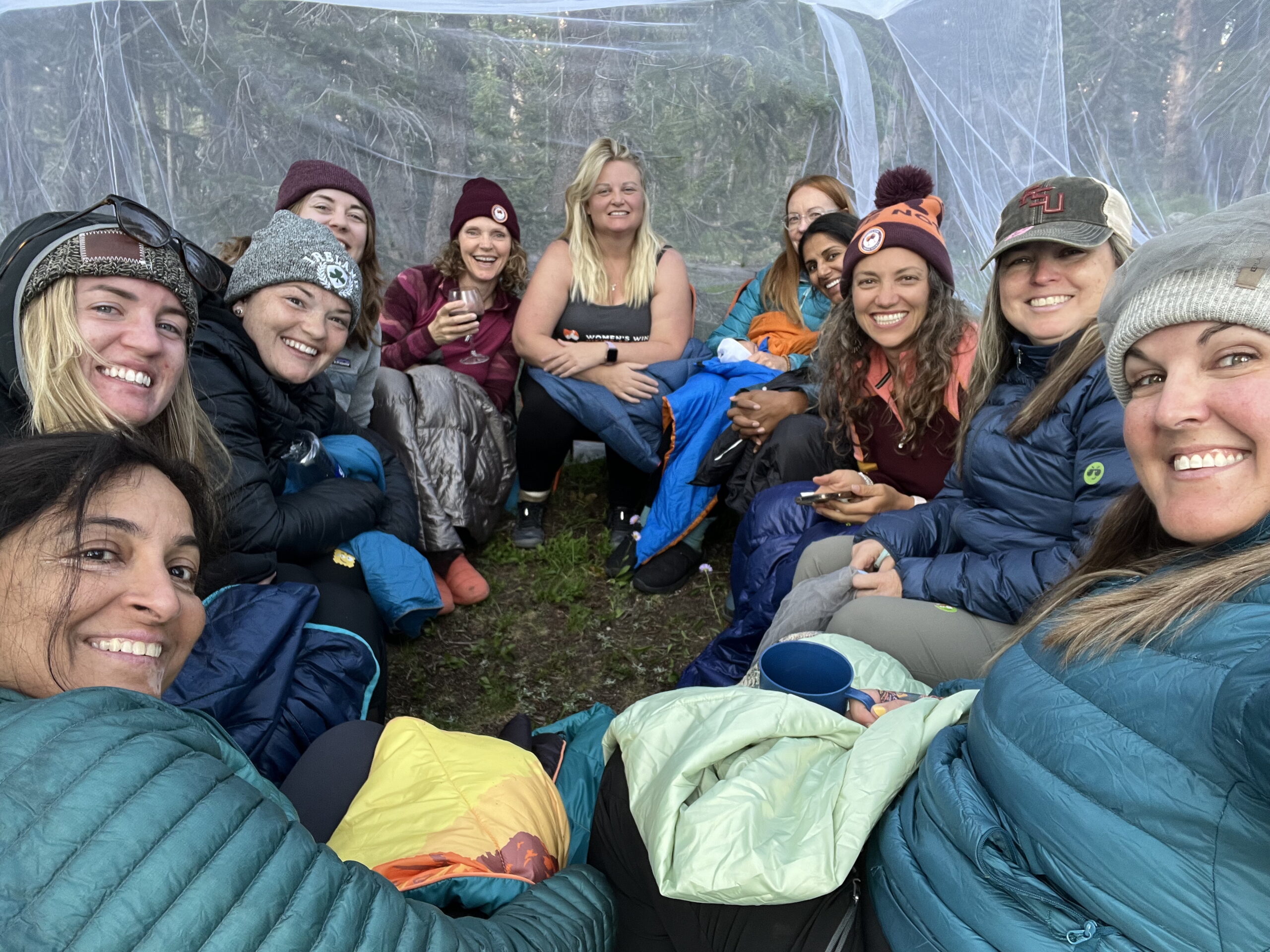 Women hanging out in a bug new to get away from mosquitoes while backpacking in the Uinta Mountains of Utah