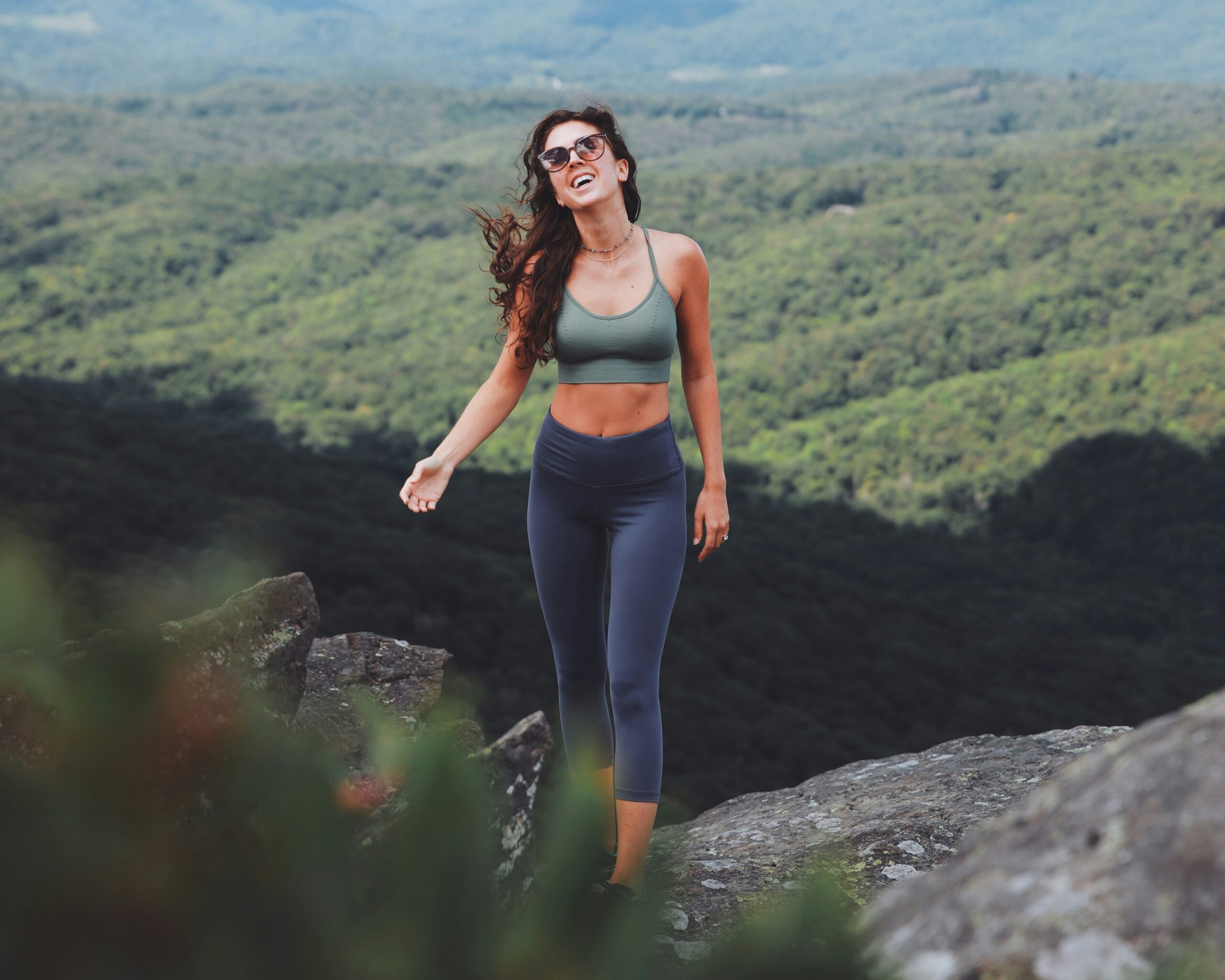 woman hiking in leggings and a sports bra