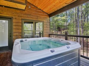 Enjoy relaxing in the hot tub on the covered porch of this beautiful log cabin near Broken Bow Lake in Oklahoma