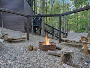 Enjoy relaxing around the fire pit of this beautiful log cabin near Broken Bow Lake in Oklahoma